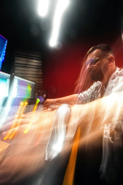 man playing electronic music in front of a tv