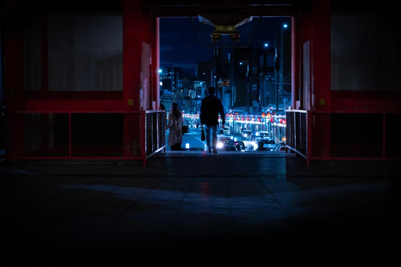 a person standing out the door of an alley at night