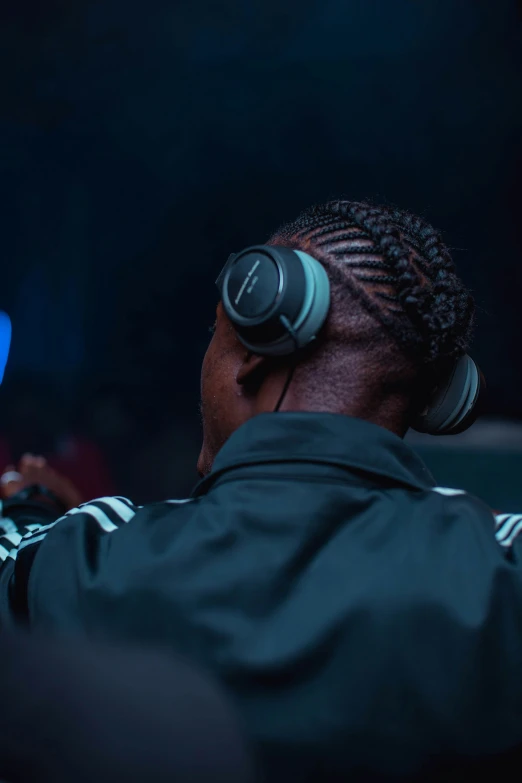 a person wearing headphones in a darkened room