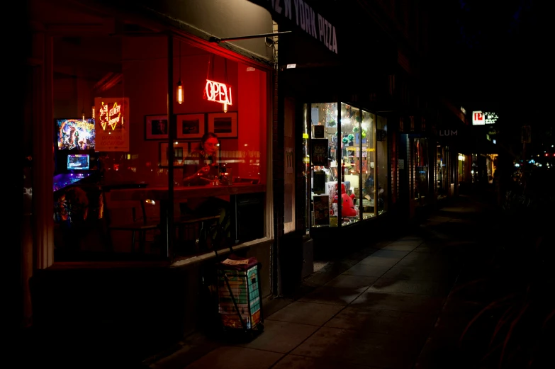 storefront in the dark on a crowded city street