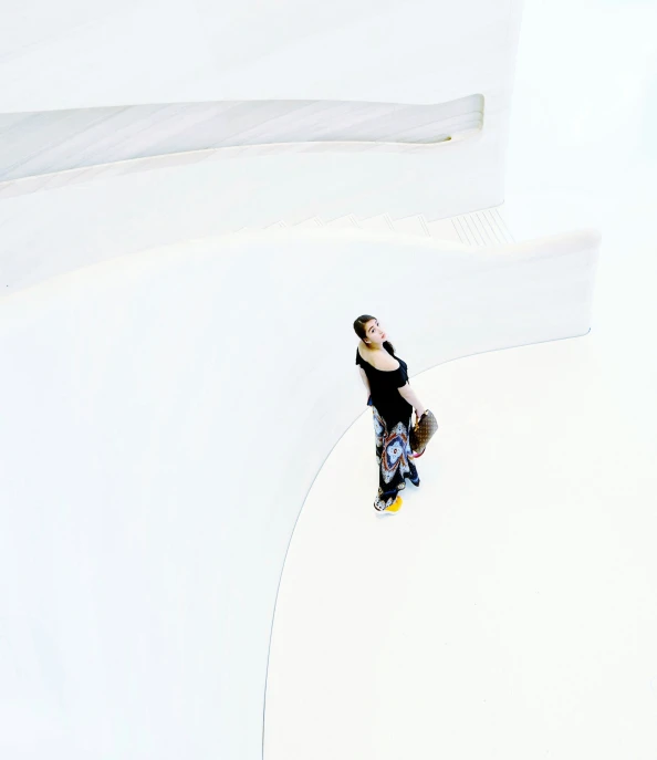 a person on a skateboard standing in the middle of an area with an arch