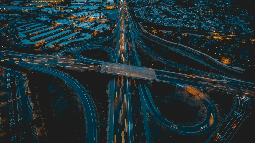 an aerial view of a street intersection, in the night