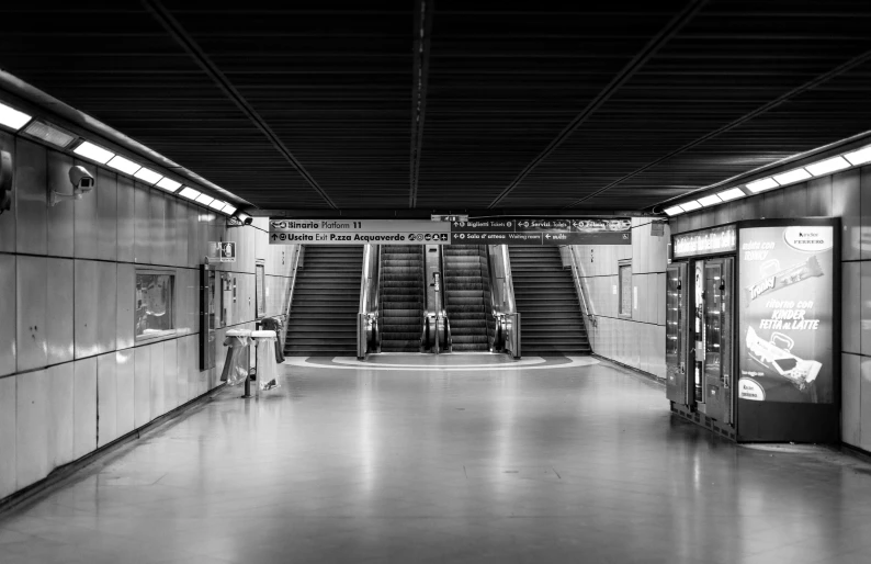 people waiting on an escalator at an underground metro station