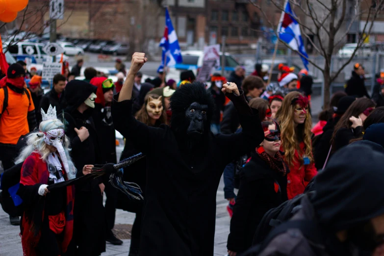 many people wearing costumes and holding flags, some with masks