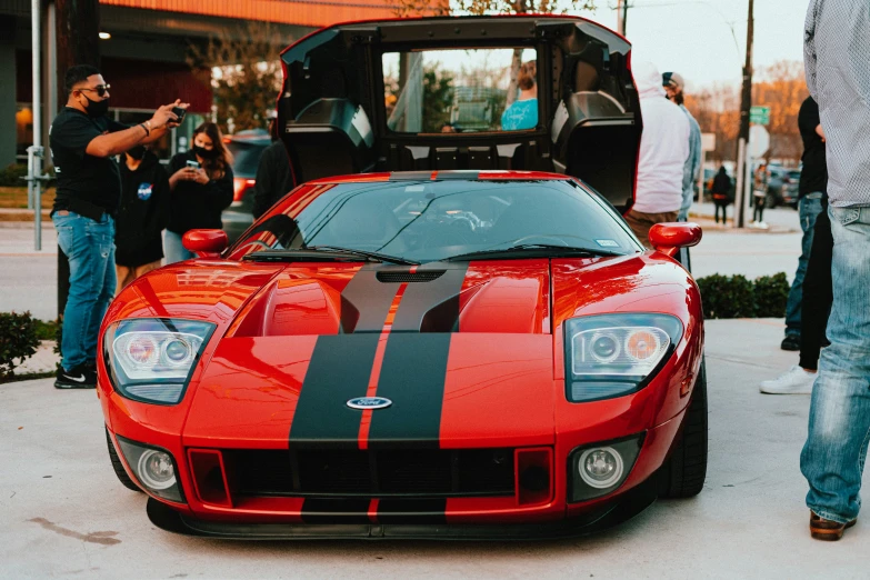 a close up view of a red and black race car on the street