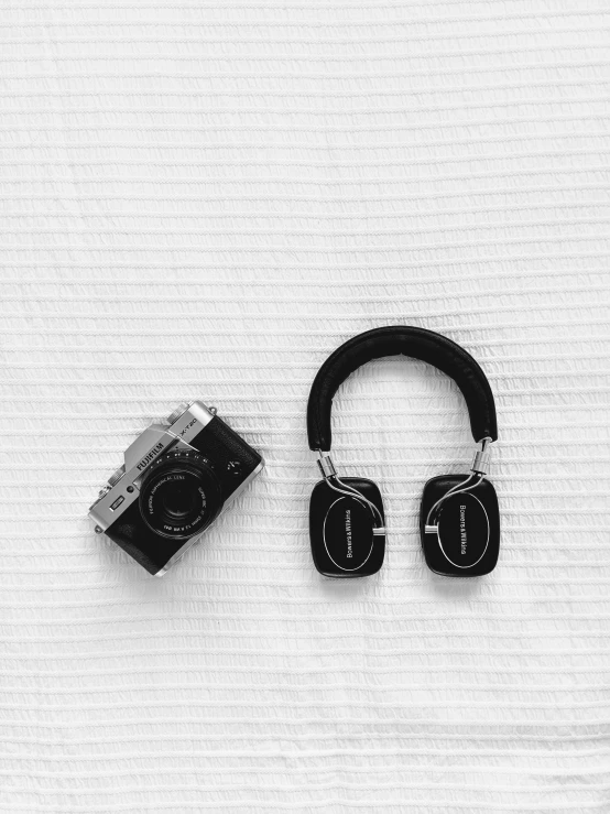 a black and white po of headphones sitting on the ground