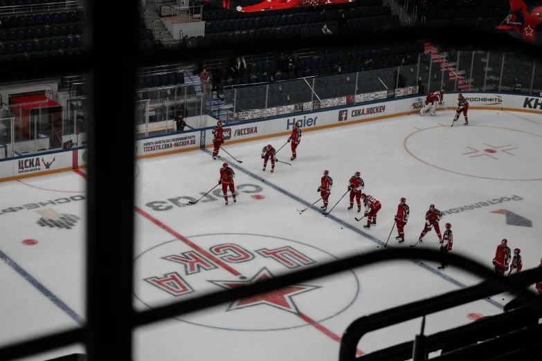 an ice hockey game from behind the goalie's net