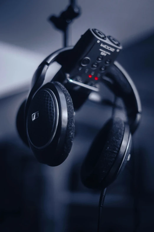 a close up of a pair of headphones near a guitar