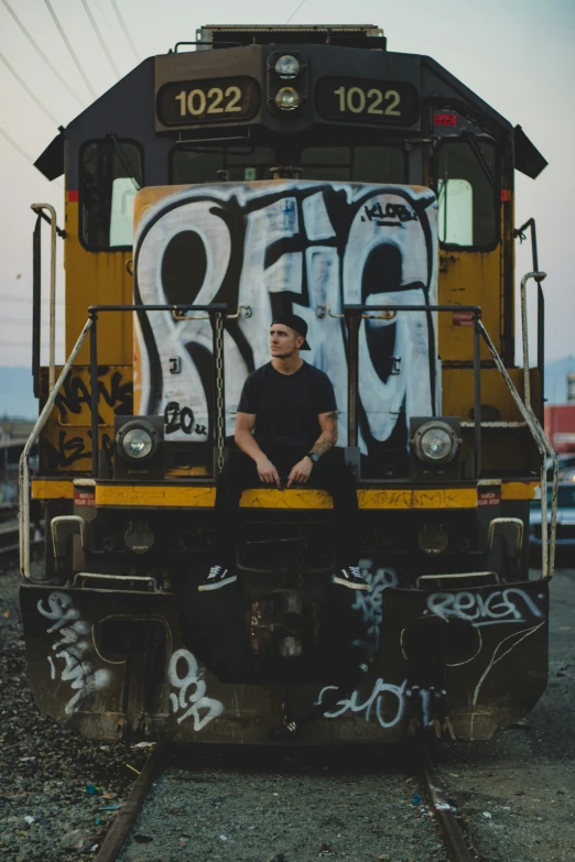 a person sitting on the front of a train