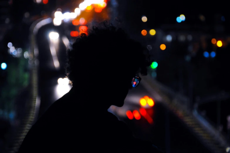 a person is looking at the lights on a street