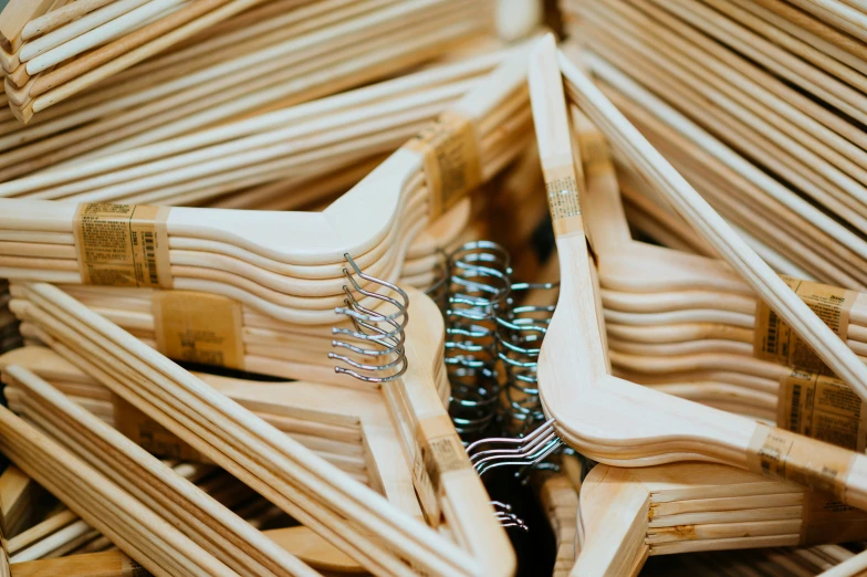 a group of wooden chairs stacked up next to each other