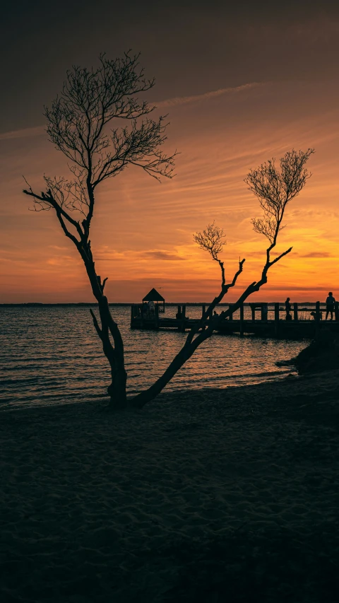 a very pretty sunset on the beach with a boat