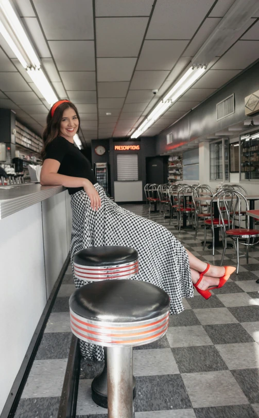 a woman sitting at a counter next to a table