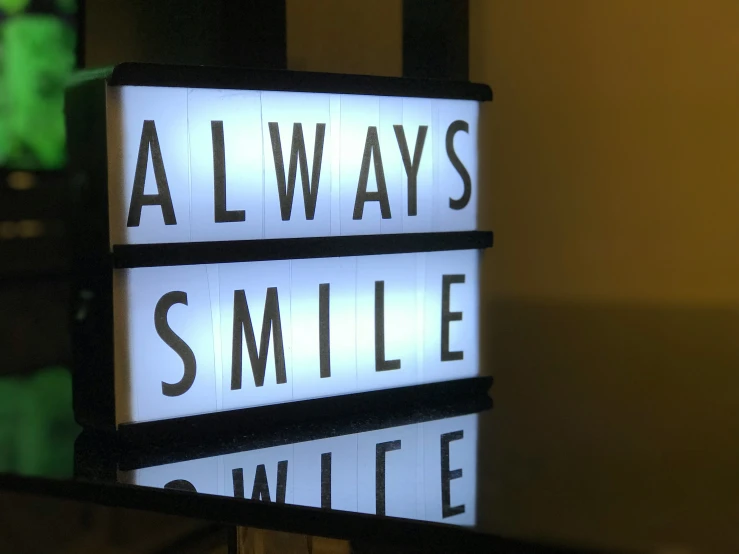 lights shine white beneath the words always smile