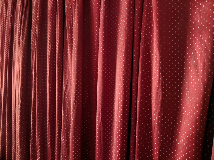 a row of red curtains with white polka doting