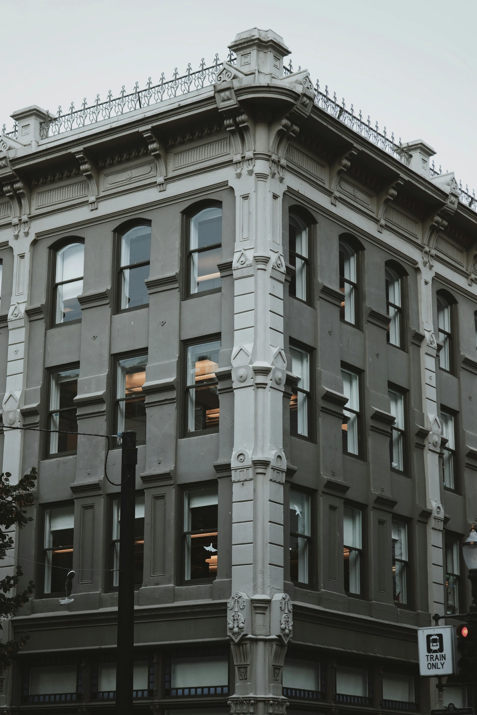 a tall building is lit up by street lights