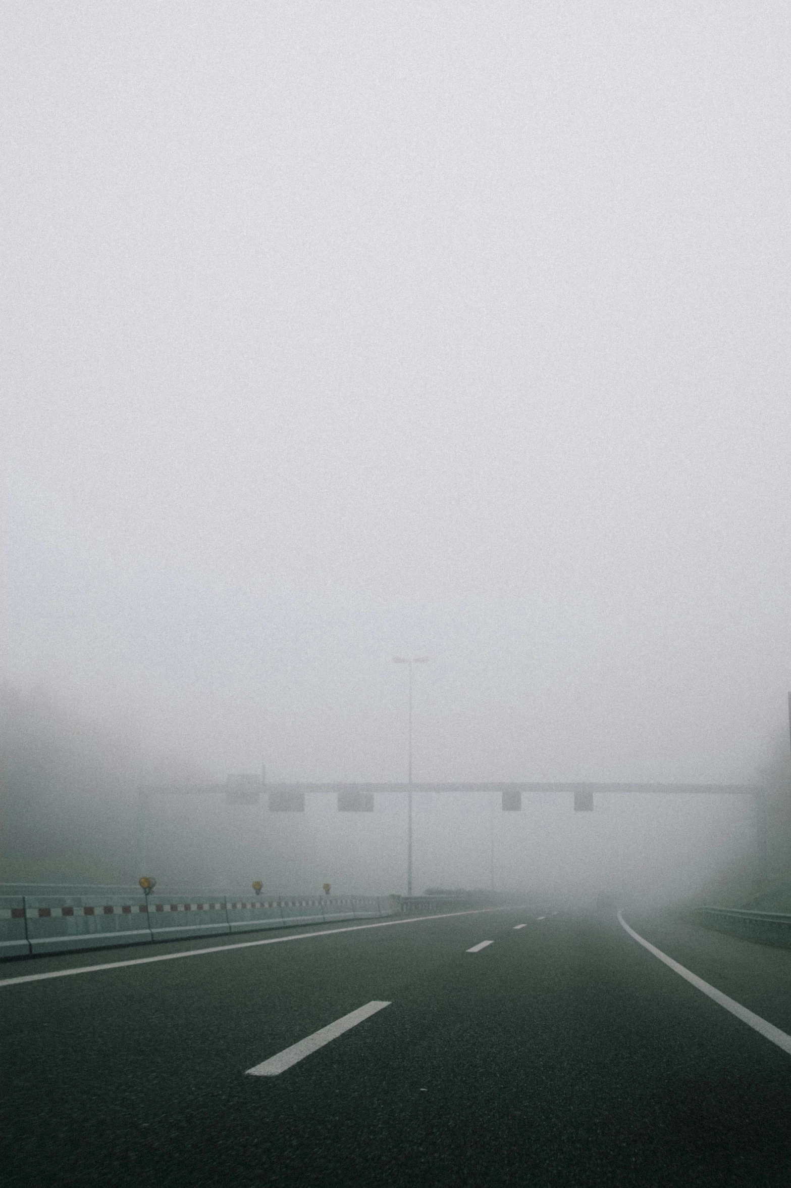 fog on a road with a traffic light