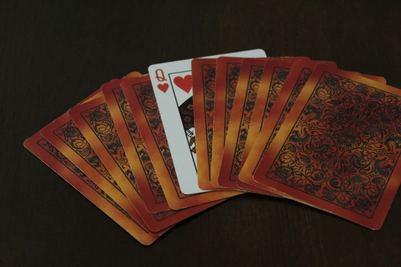 five cards with gold trim and orange designs