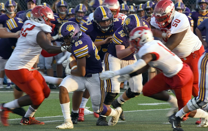 a football game with the team running to the receiver