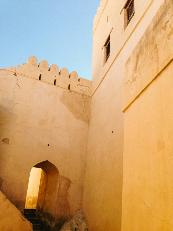 the doorways and walls of this old building are partially covered with mud