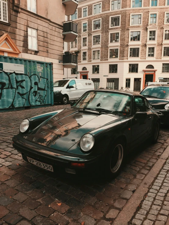 a vintage car parked on the side of a street