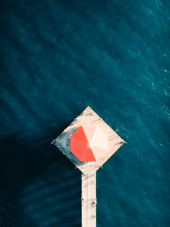 the square shaped object is on the pole near the water