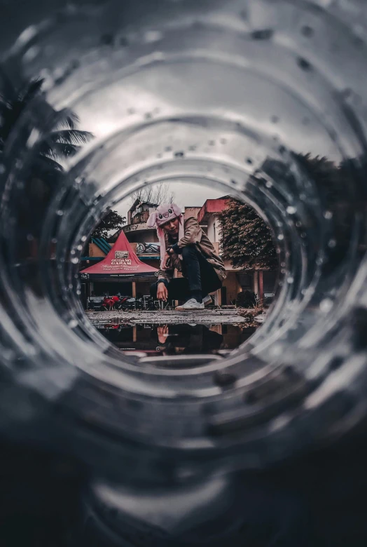 a glass bottle with reflection of the house