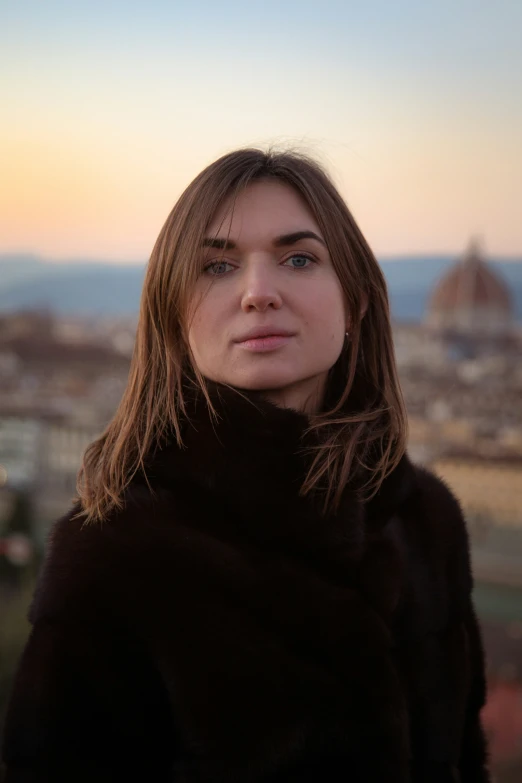 woman looking at camera in front of cityscape