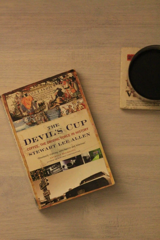 a book titled devil's cup is on the table