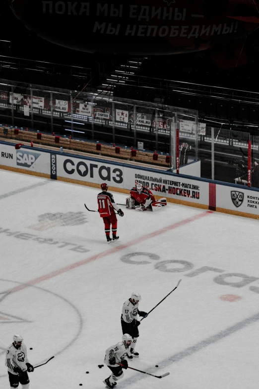 a hockey game with players on the ice and some in white uniform