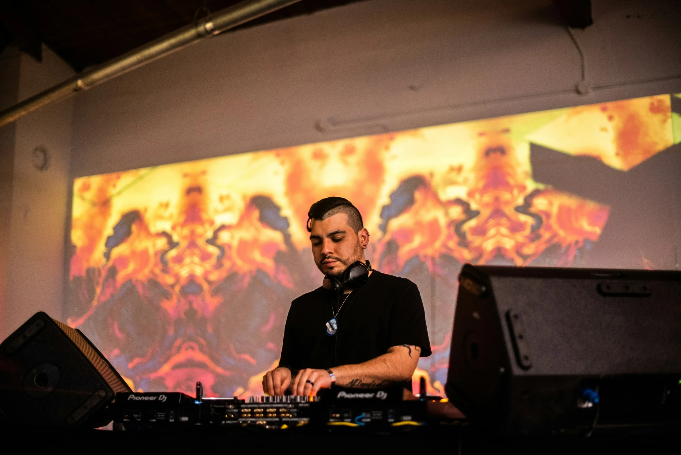 a man is operating a turntable in front of a video projection