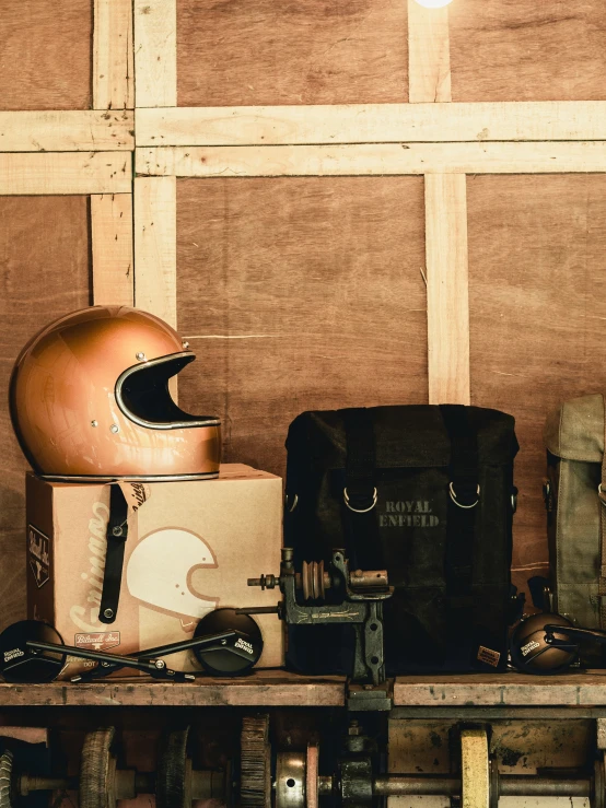 a helmet, suitcases, and other tools on a shelf