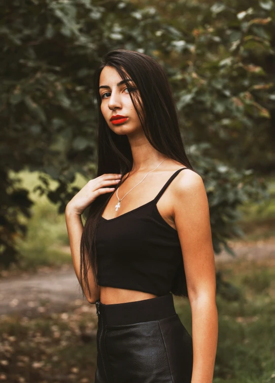 a woman is posing in the woods