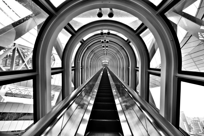 black and white po of a long escalator