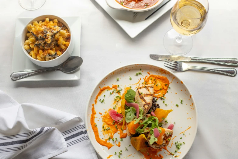 plates of food including pasta and vegetables on a table