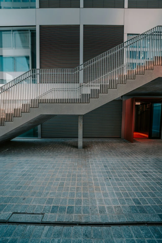 a tall building with a staircase between two buildings