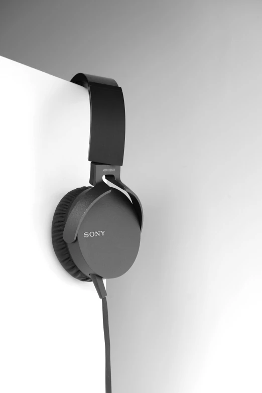 sony headphone hanging up against the wall