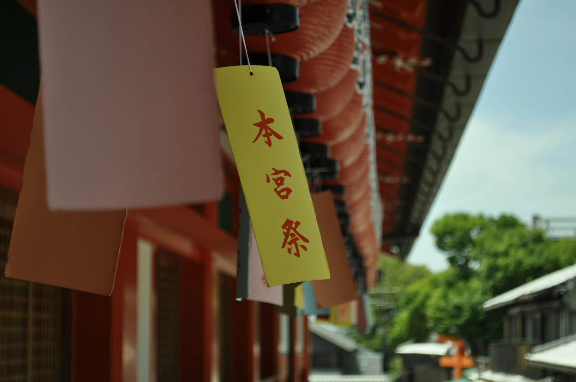 a yellow chinese sign attached to a red building