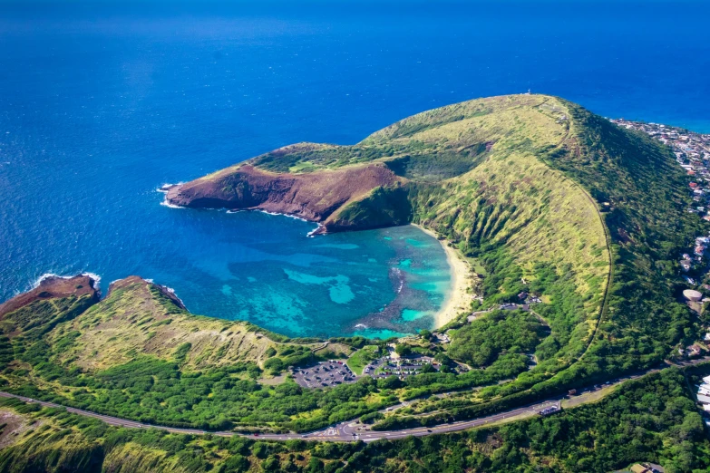 an island in the ocean with a blue water