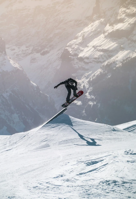 a snowboarder is on the snowy mountain slope