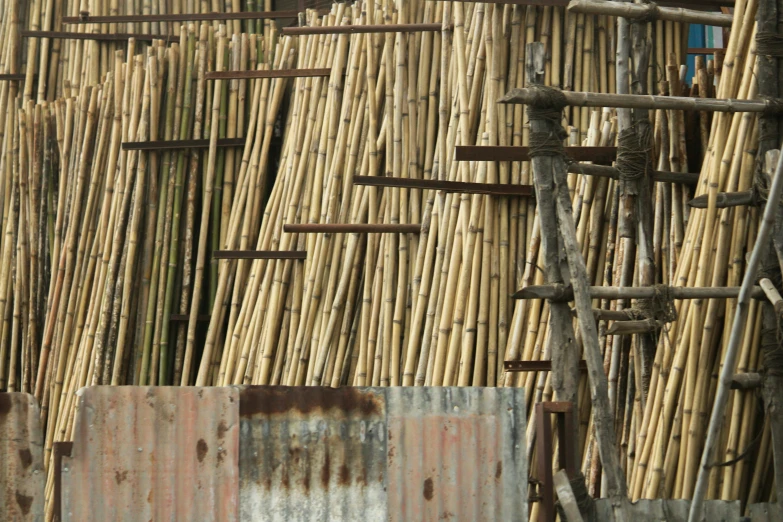 wooden pole with rusty iron bars in front of a building