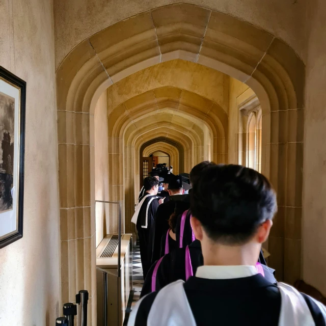 people standing in line at a staircase entrance