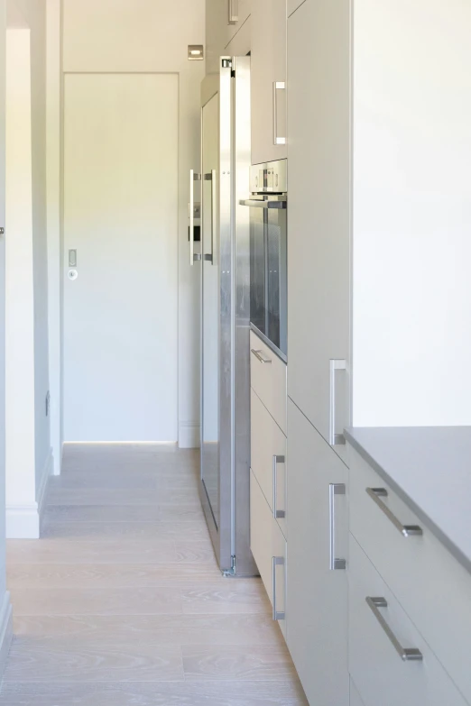 a long narrow kitchen with stainless steel appliances