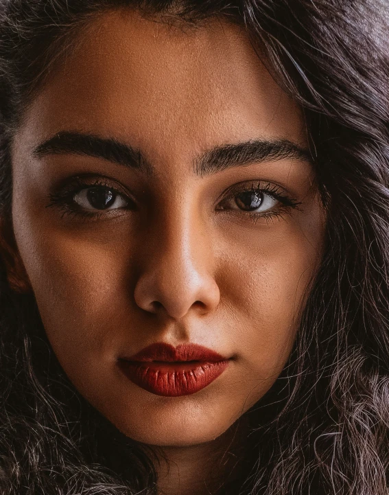 a woman with a fur collar looks down and is making her face