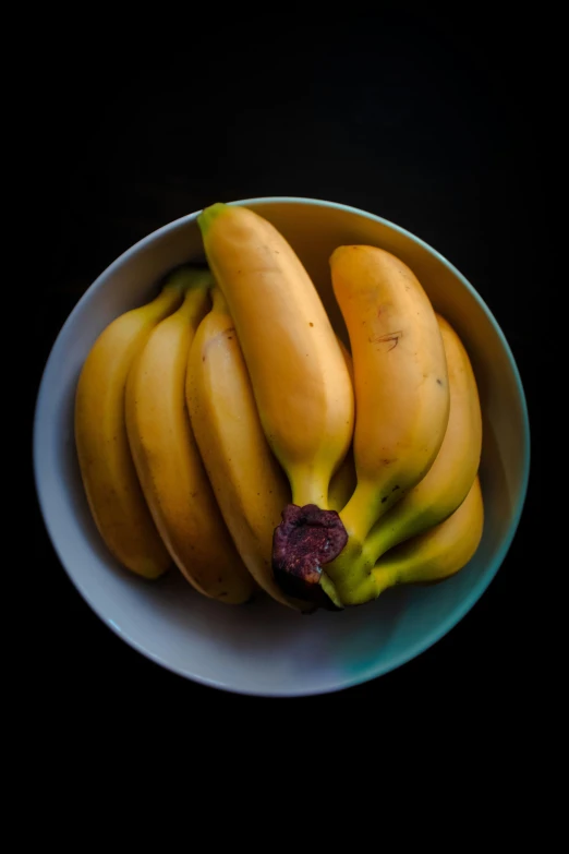 a large bowl of fresh fruit with bananas on the side