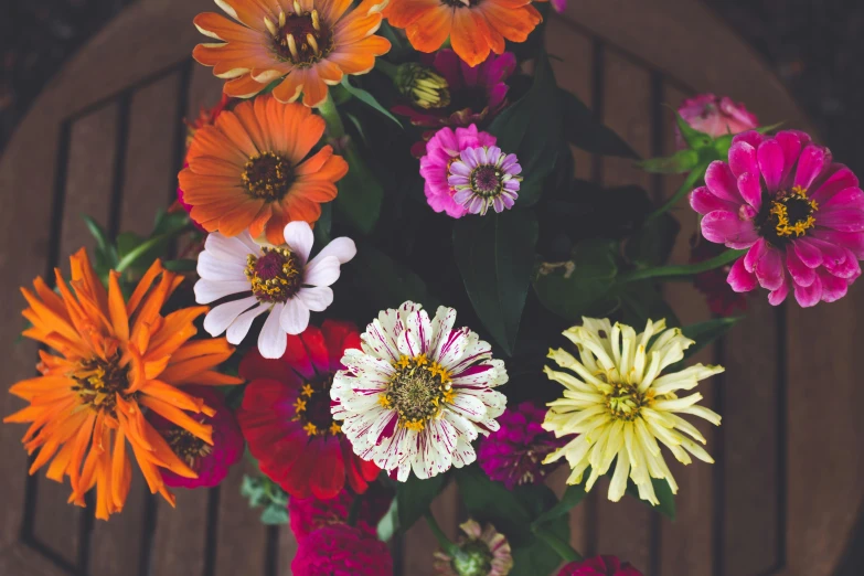 flowers are arranged in many colors of the same vase