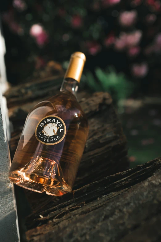 a close up of a wine bottle on a wooden ledge