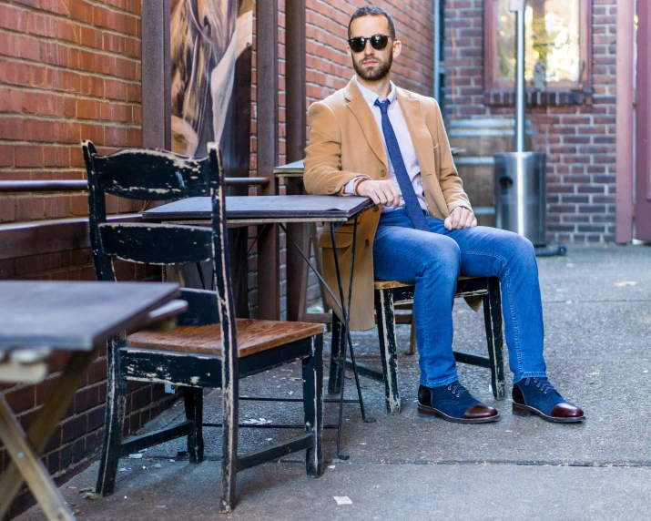 a man sitting at a table in a cafe chair