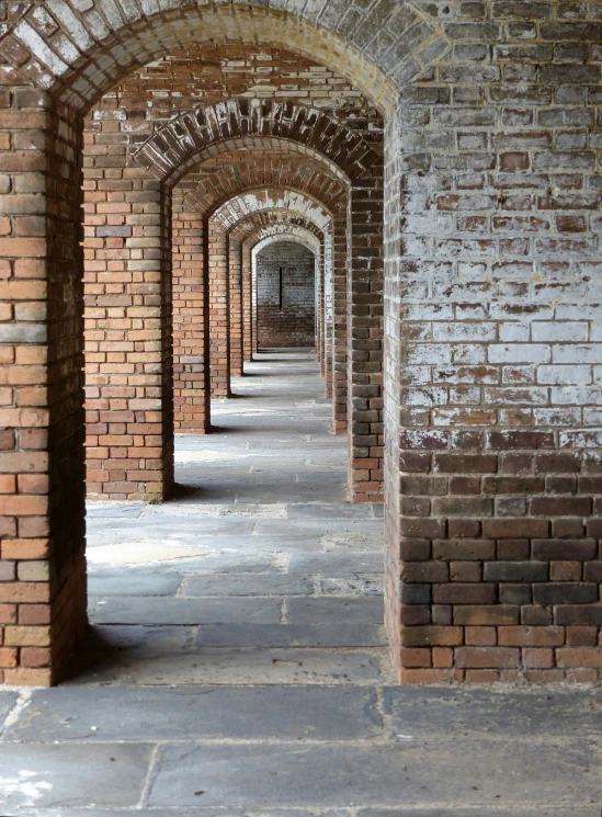 a row of brick pillars in an alley way