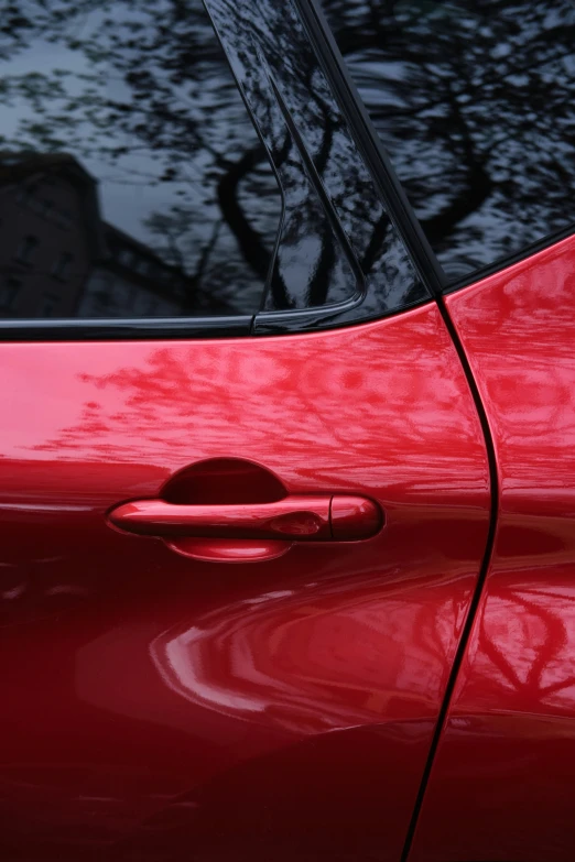 red car door handles showing with a lot of rain